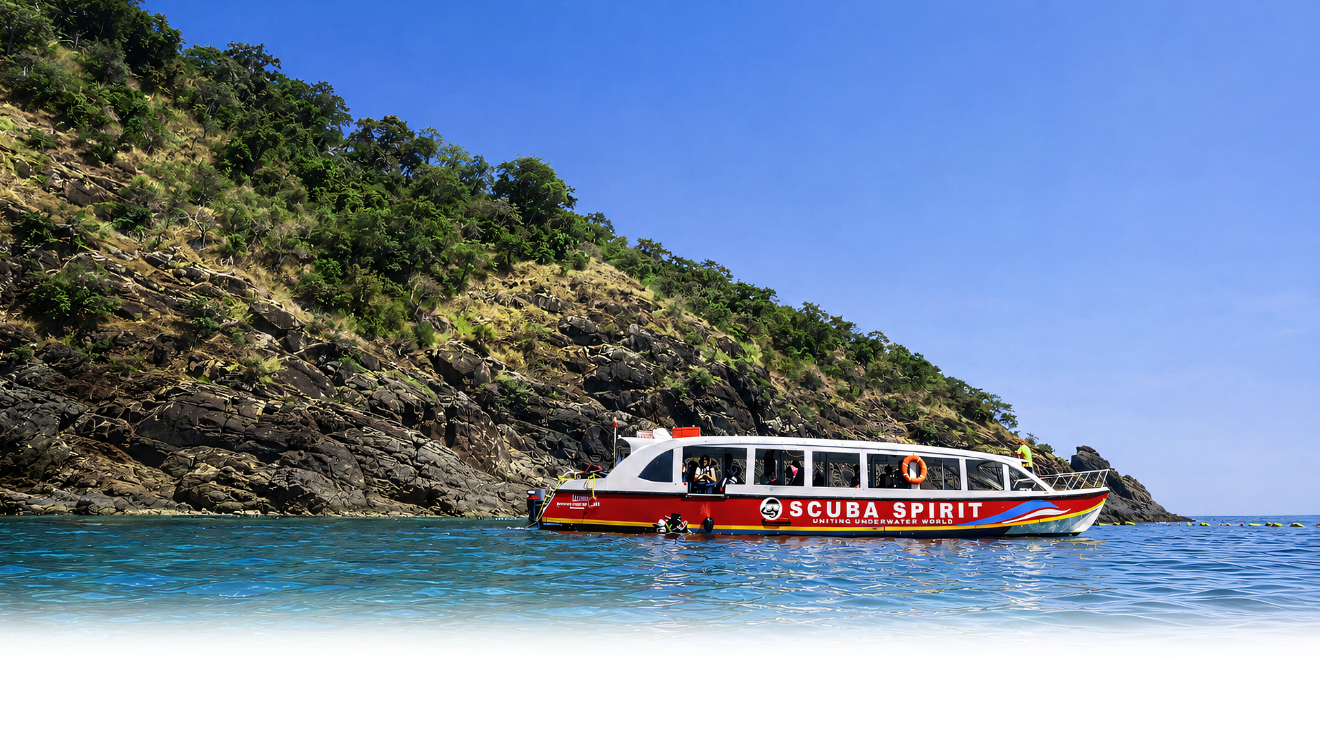 Scuba Spirit dive boat on turquoise water near Netrani Island, Murudeshwar